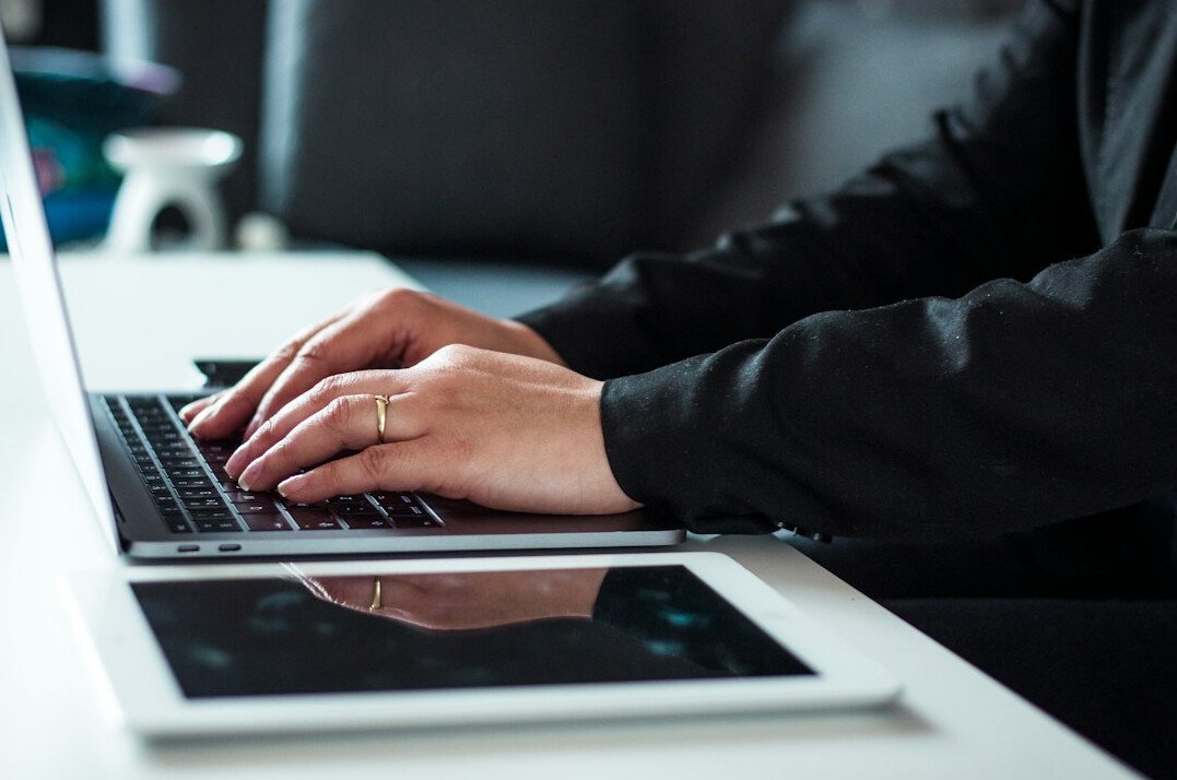 professional writing email on laptop